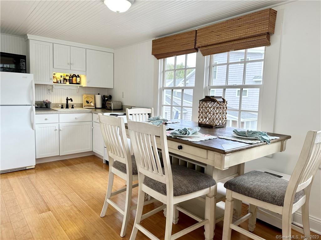 15 Tuxis Road Madison, CT 06443 - Photo 9 of 27 a kitchen with a stove a sink and a refrigerator