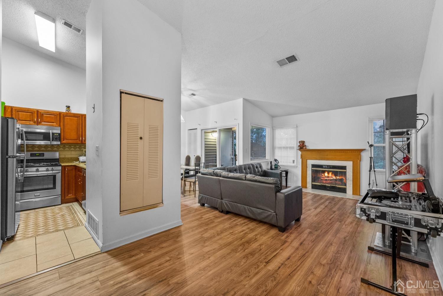 a living room with furniture flat screen tv and a fireplace