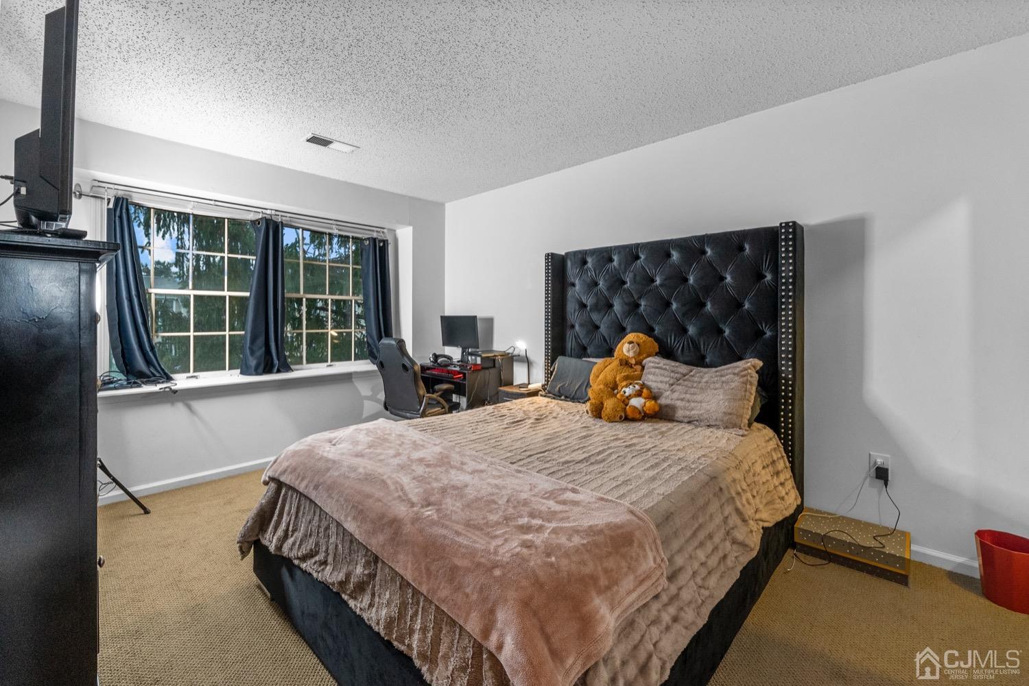 1237 Edpas Road New Brunswick, NJ 08901 - Photo 13 of 21 a bed sitting in a bedroom next to a window