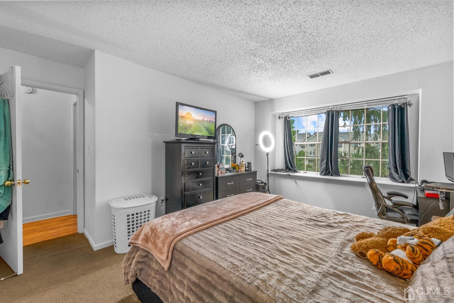 1237 Edpas Road New Brunswick, NJ 08901 - Photo 14 of 21 a bedroom with a bed and a tv on table