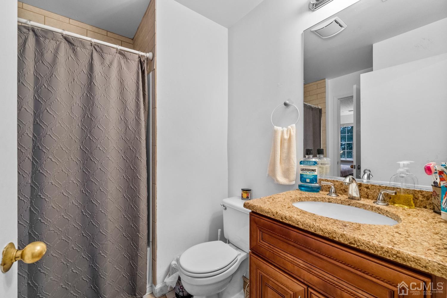 1237 Edpas Road New Brunswick, NJ 08901 - Photo 17 of 21 a bathroom with a granite countertop sink toilet and mirror
