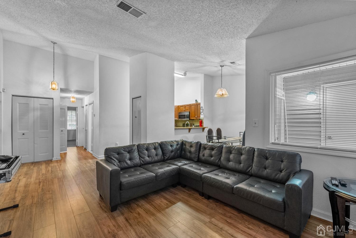 1237 Edpas Road New Brunswick, NJ 08901 - Photo 2 of 21 a view of a living room a wooden floor and a chandelier