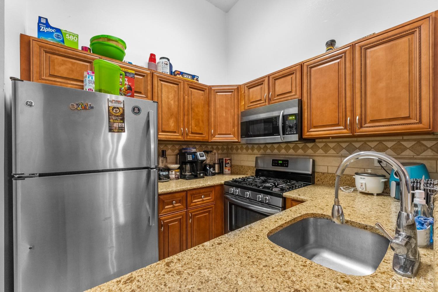 1237 Edpas Road New Brunswick, NJ 08901 - Photo 7 of 21 a kitchen with stainless steel appliances granite countertop a refrigerator a stove top oven a sink and dishwasher