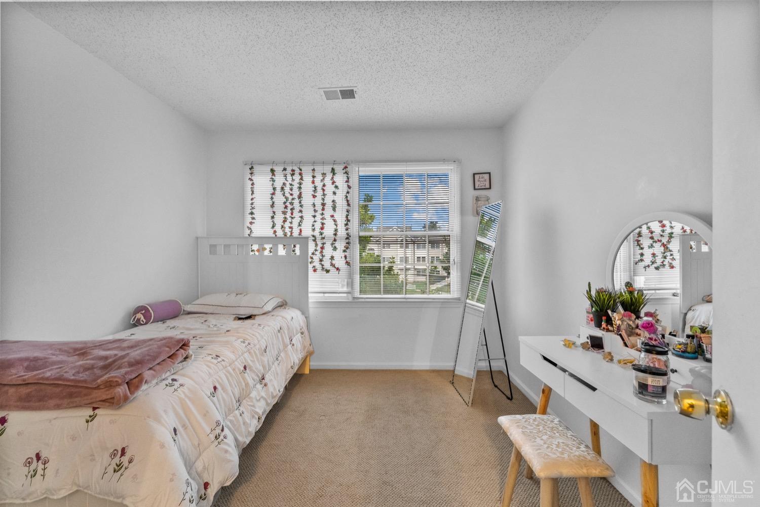 1237 Edpas Road New Brunswick, NJ 08901 - Photo 10 of 21 a bedroom with a bed and a chair
