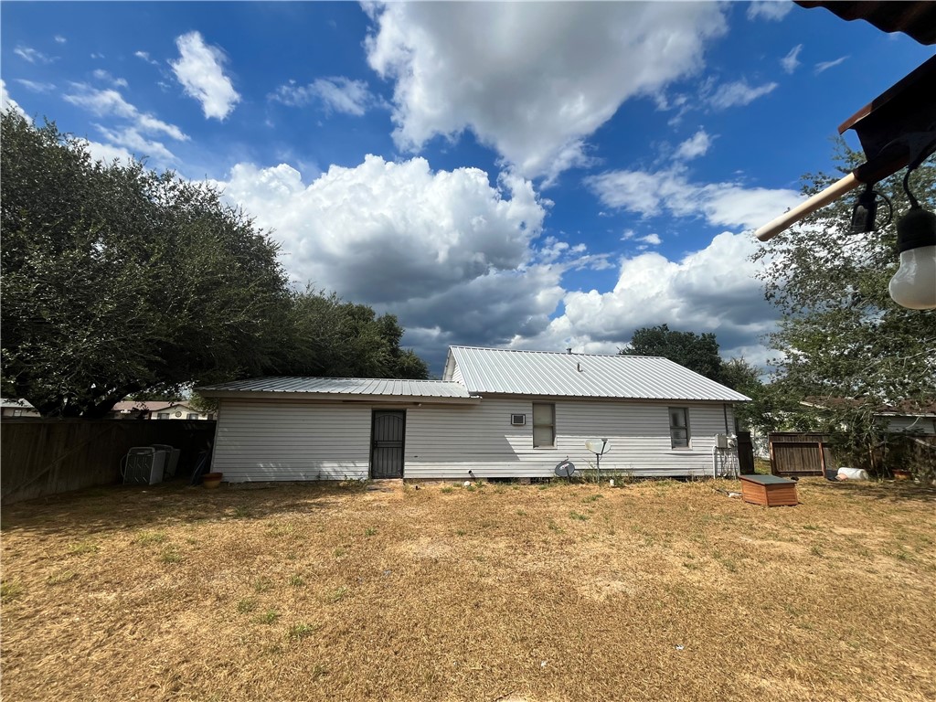 305 East Laredo Street Freer, TX 78357 - Photo 3 of 19 a front view of house with yard and trees in the background