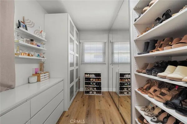 a kitchen with stainless steel appliances cabinets and a wooden floor