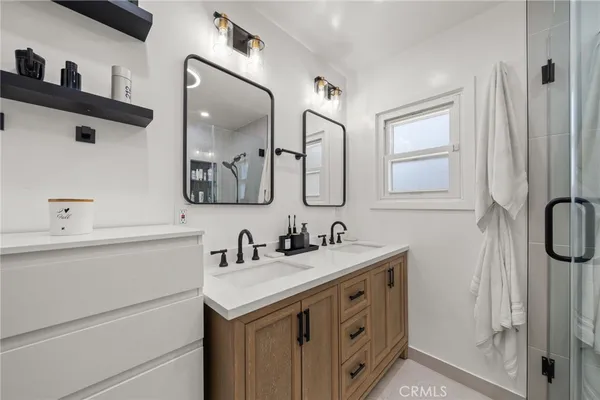 a bathroom with a double vanity sink mirror and