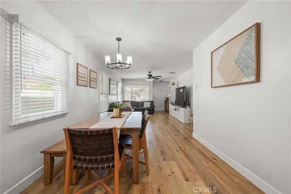 a view of a dining room with furniture and chandelier