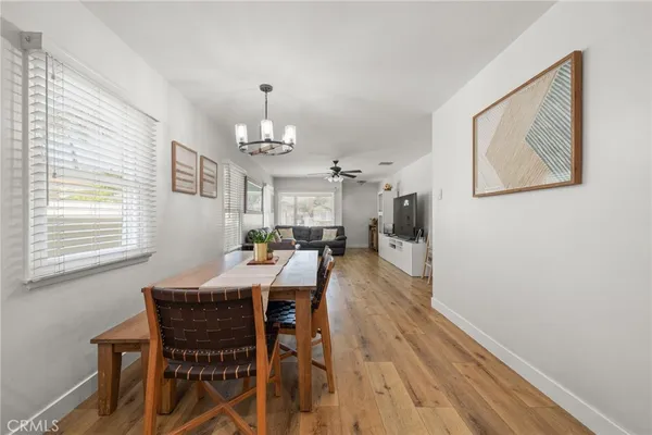 a view of a dining room with furniture and chandelier