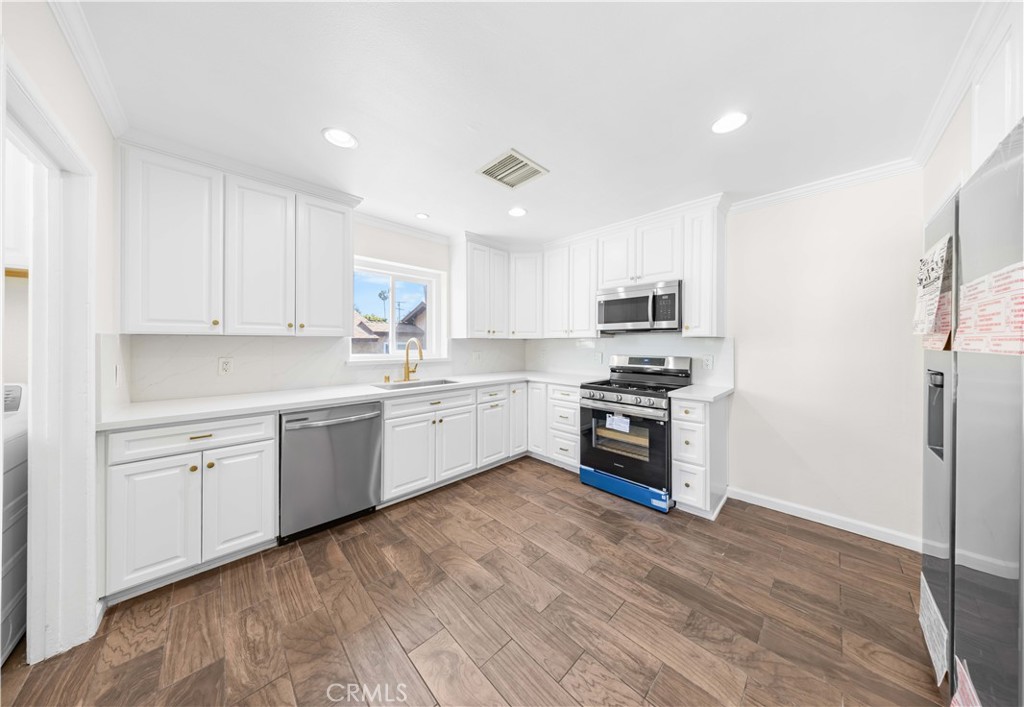 2074 Summit Avenue Pasadena, CA 91103 - Photo 13 of 23 a kitchen with granite countertop white cabinets and stainless steel appliances