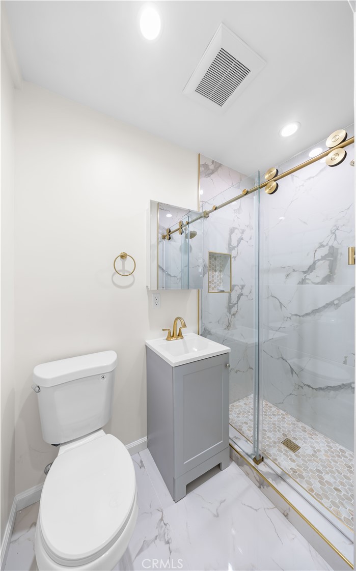 2074 Summit Avenue Pasadena, CA 91103 - Photo 8 of 23 a white toilet sitting next to a bathroom sink
