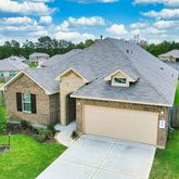 a aerial view of a house with a yard and table and chairs