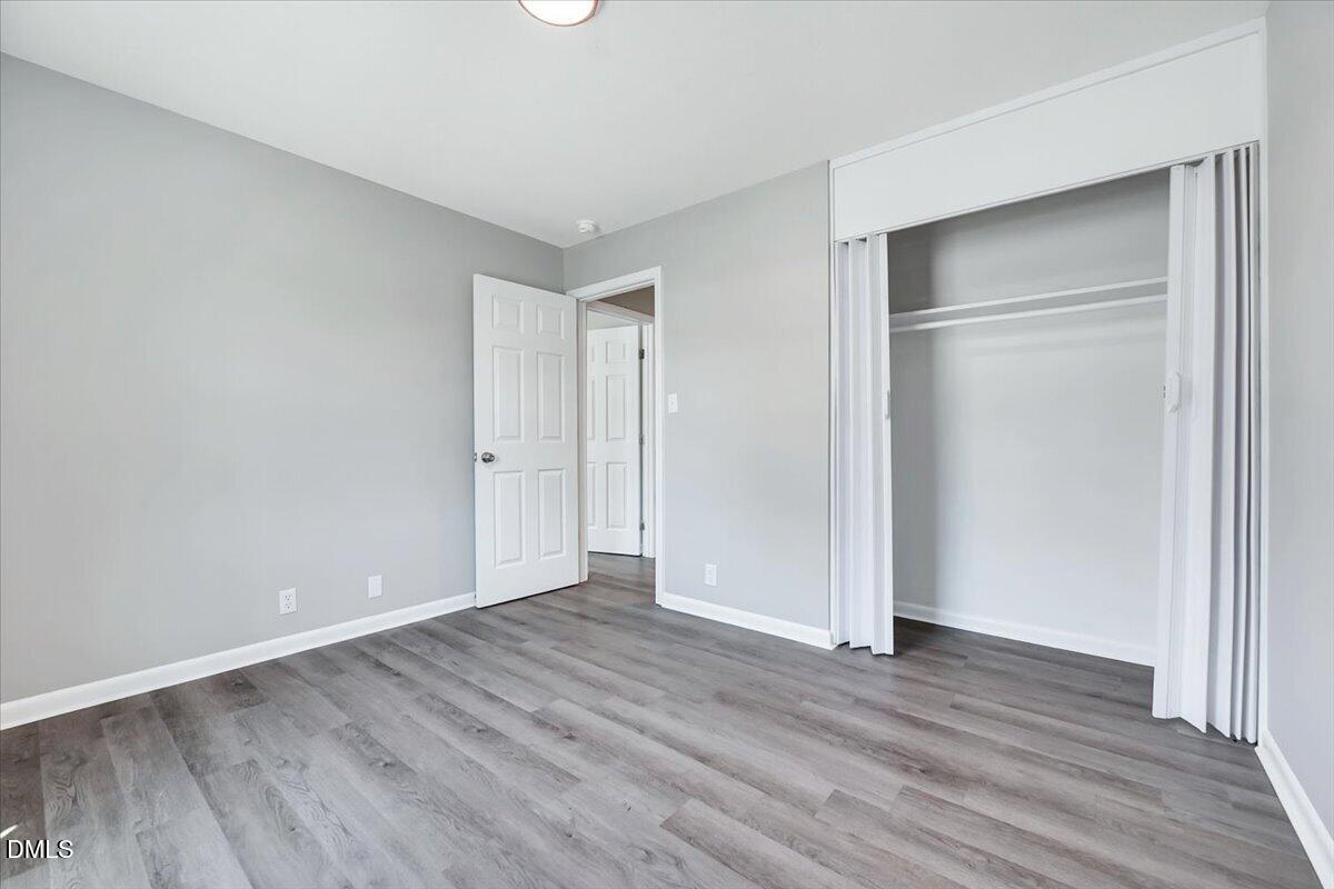 3408 Atlantic Avenue Raleigh, NC 27604 - Photo 41 of 48 a view of an empty room with wooden floor