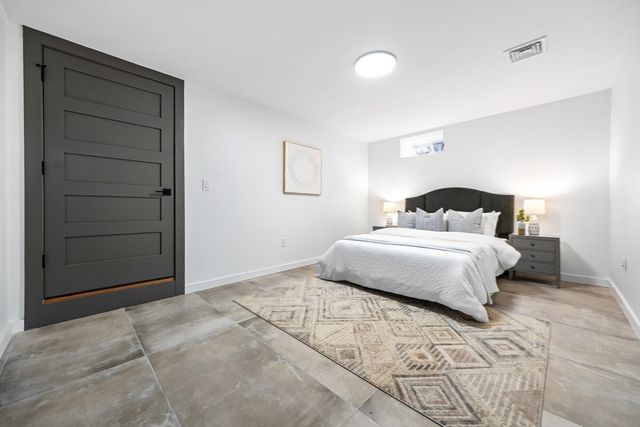 a bedroom with a bed and a cabinets