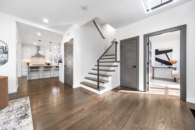 a view of a livingroom with wooden floor and furniture