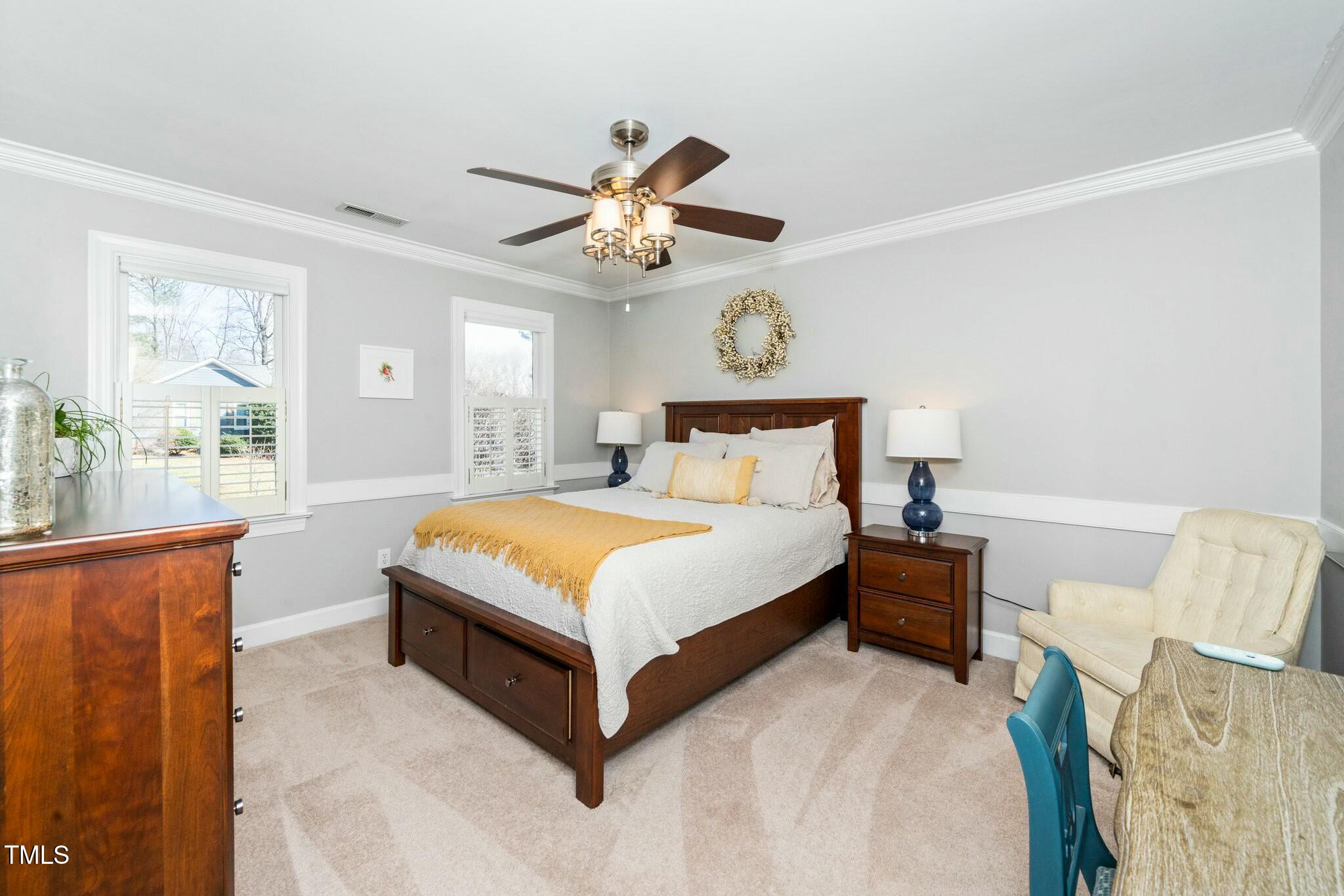 2400 Dahlgreen Road Raleigh, NC 27615 - Photo 18 of 36 a bedroom with a large bed and a chandelier