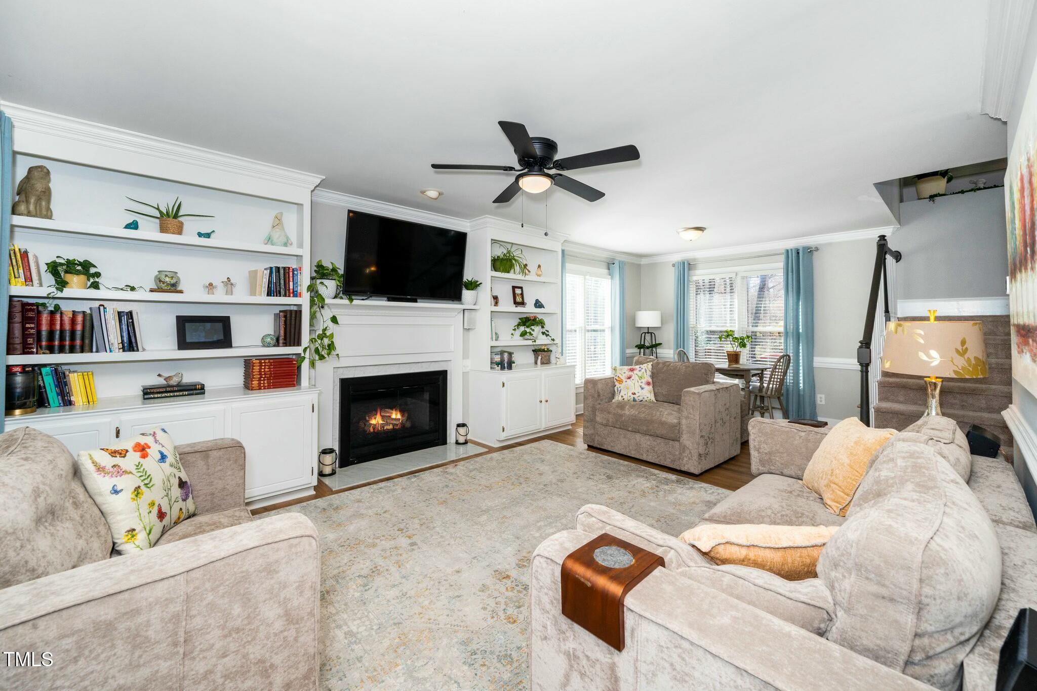 2400 Dahlgreen Road Raleigh, NC 27615 - Photo 6 of 36 a living room with furniture a flat screen tv and a fireplace