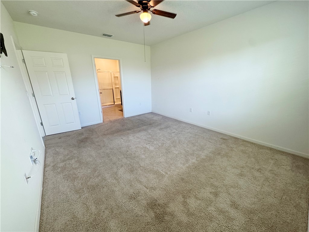 1836 Barber Street Sebastian, FL 32958 - Photo 24 of 29 an empty room with windows and ceiling fan