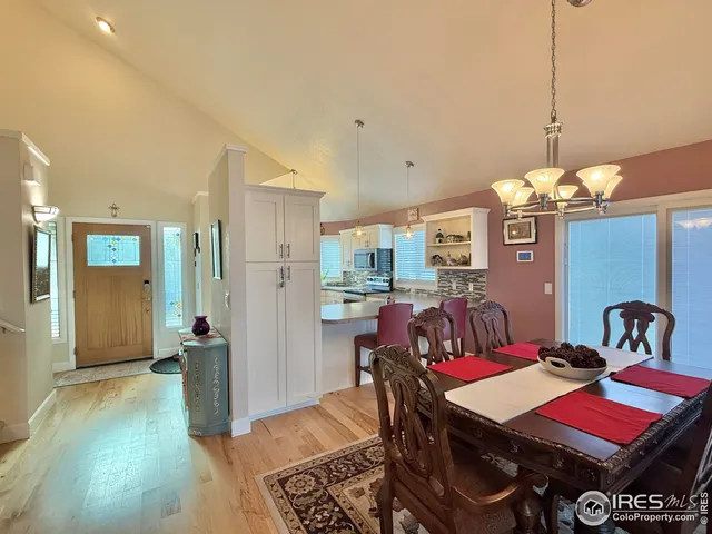 a dining room with furniture and wooden floor