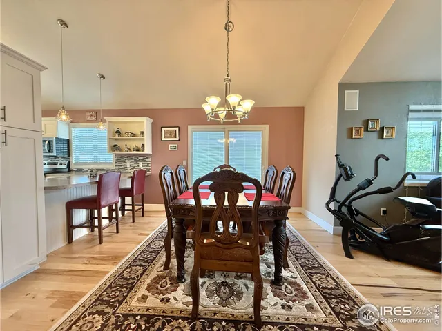 a view of a dining room with furniture and chandelier