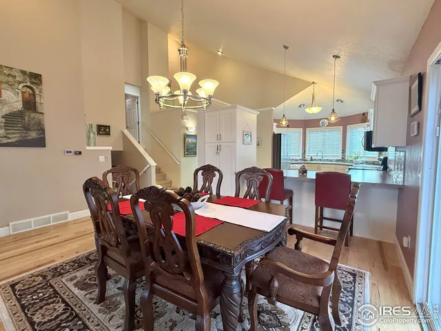 a view of a dining room with furniture and chandelier