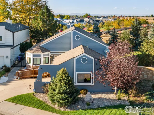 aerial view of a house with a yard and plants