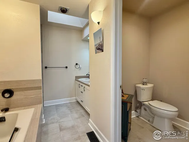 a bathroom with a toilet sink and shower