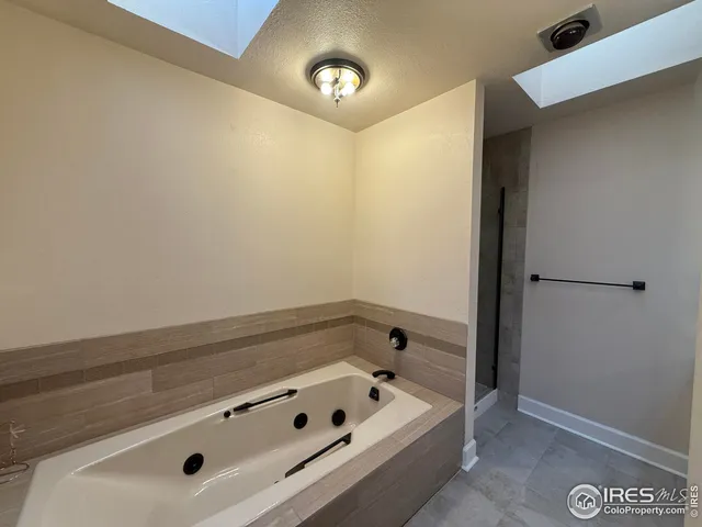 a bathroom with a tub and a sink