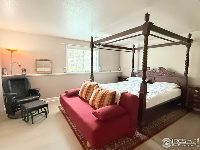 a bedroom with a bed window and a couch