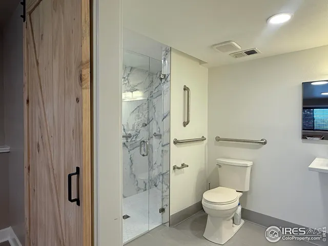 a bathroom with a toilet and a shower
