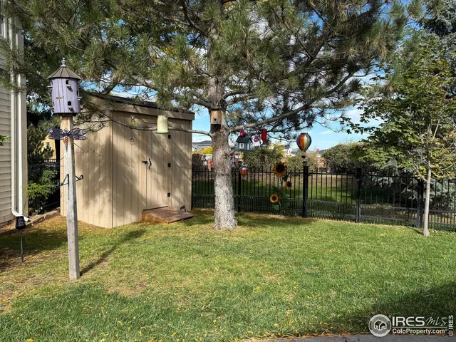 a view of a park with iron fence
