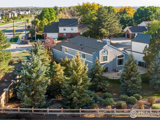 an aerial view of a house with yard