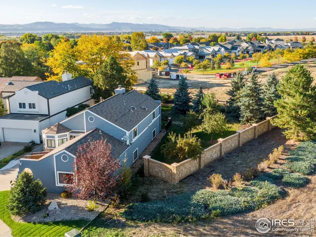 an aerial view of residential houses with outdoor space and swimming pool
