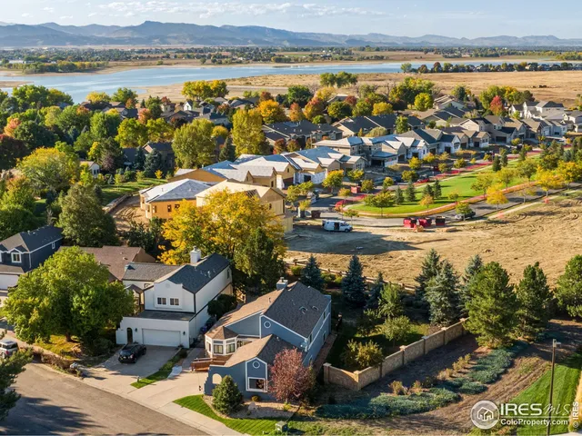 an aerial view of residential houses with outdoor space and river