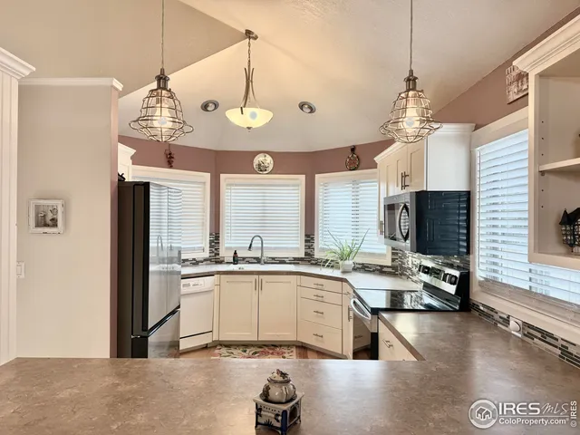 a kitchen with stainless steel appliances granite countertop a stove and cabinets