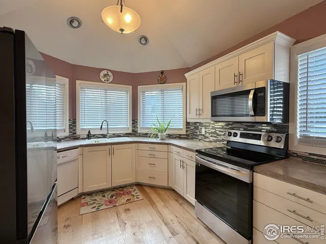 a kitchen with stainless steel appliances granite countertop a stove and a sink