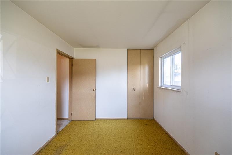 103 Louis Drive McKees Rocks, PA 15136 - Photo 12 of 24 Second bedroom with window and closet. (Hardwood floors beneath carpeting.)