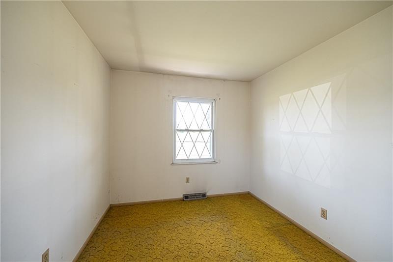 103 Louis Drive McKees Rocks, PA 15136 - Photo 13 of 24 Another view of the second bedroom with window and closet. (Hardwood floors beneath carpeting.)