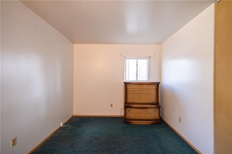 103 Louis Drive McKees Rocks, PA 15136 - Photo 15 of 24 View of the third - and largest - bedroom with window and closet. (Hardwood floors beneath the carpeting.)