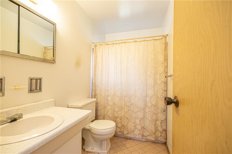 103 Louis Drive McKees Rocks, PA 15136 - Photo 16 of 24 Full, main bath with tub and shower, plus vanity with one bowl sink, and ceramic tile flooring.