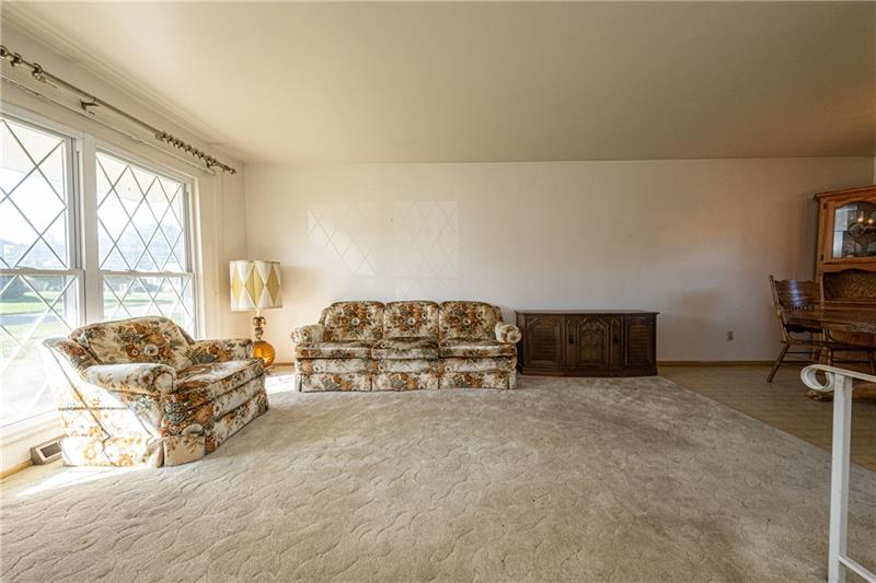 103 Louis Drive McKees Rocks, PA 15136 - Photo 3 of 24 Spacious living room with large, twin windows. (Hardwood floors beneath the carpeting.)