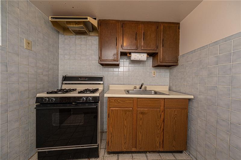 103 Louis Drive McKees Rocks, PA 15136 - Photo 21 of 24 Loads of possibilities in this basement space: Kitchen/possible laundry/mud room. Oven/stove does NOT transfer with sale of home.
