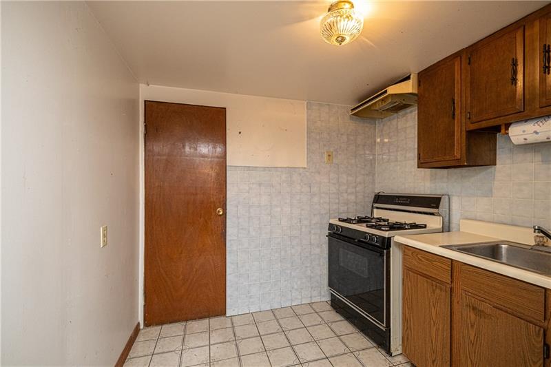 103 Louis Drive McKees Rocks, PA 15136 - Photo 22 of 24 Loads of possibilities in this basement space: Kitchen/possible laundry/mud room. Door leads to 1-car, integral garage. Oven/stove does NOT transfer with sale of home.