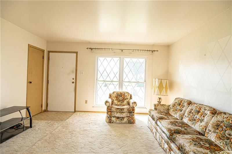 103 Louis Drive McKees Rocks, PA 15136 - Photo 4 of 24 Spacious living room with large, twin windows and coat closet.