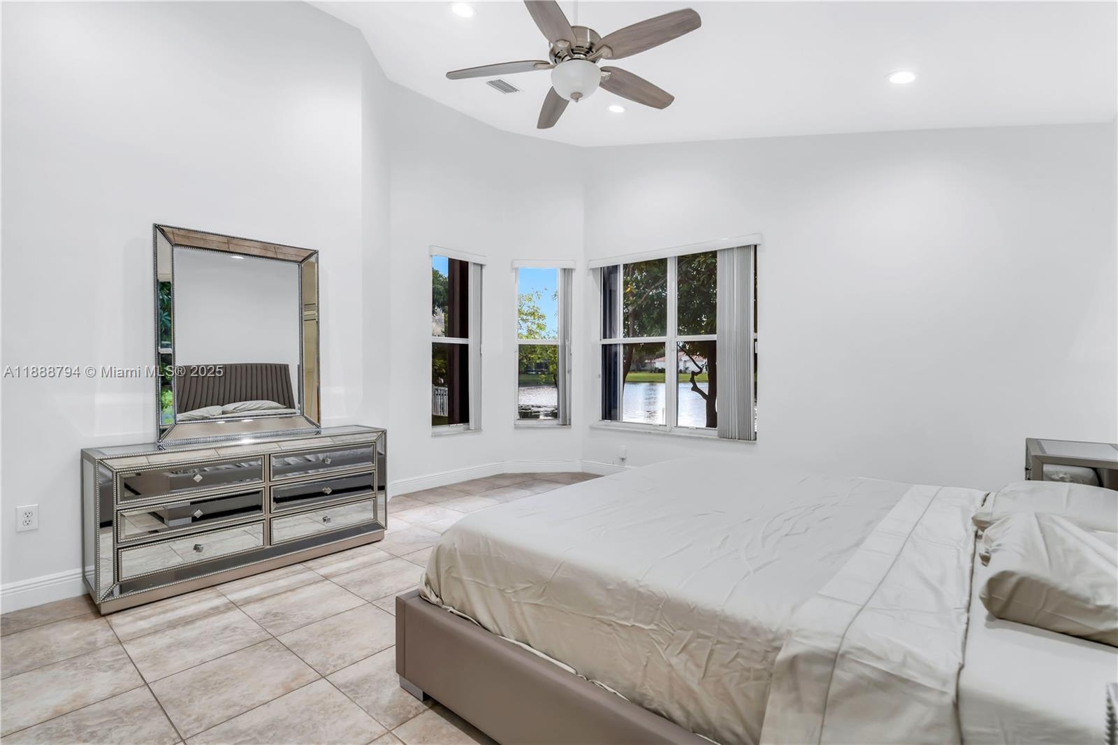 2791 Southwest 190th Avenue Miramar, FL 33029 - Photo 20 of 41 a bedroom with a bed and dresser with mirror