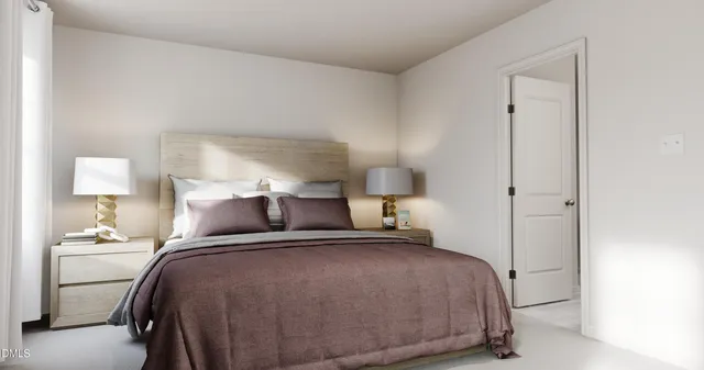 a bedroom with a bed and a lamp