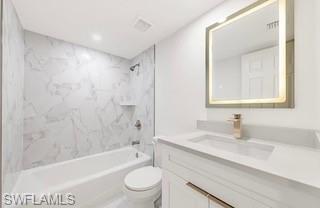 1018 Manatee Road, Unit E107 Naples, FL 34114 - Photo 10 of 15 Bathroom featuring a white vanity with gold-tone hardware, a rectangular undermount sink, and a light-framed mirror