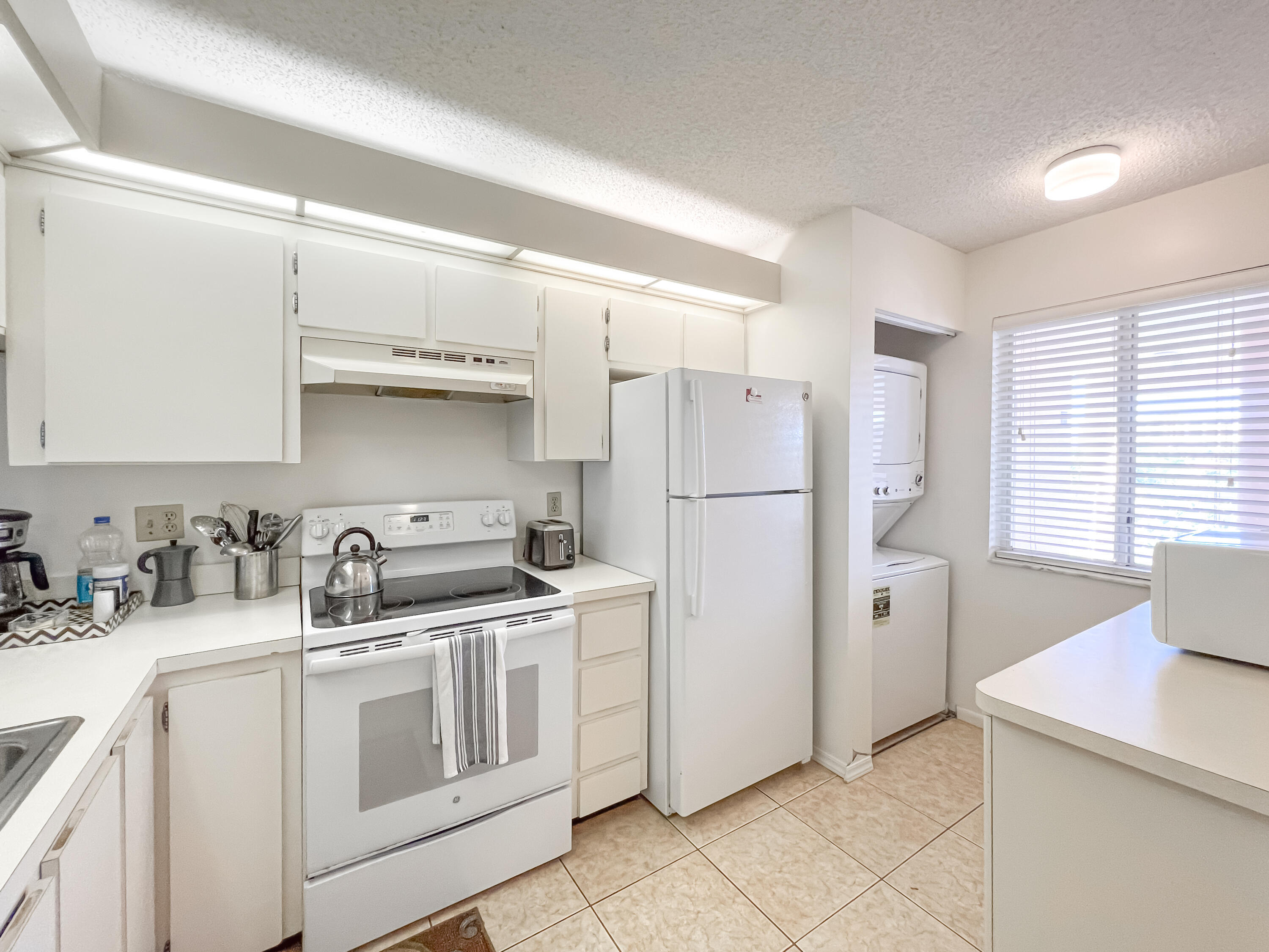 353 Highway 1, Unit B309 Jupiter, FL 33477 - Photo 2 of 24 a kitchen with stainless steel appliances granite countertop a sink stove and refrigerator