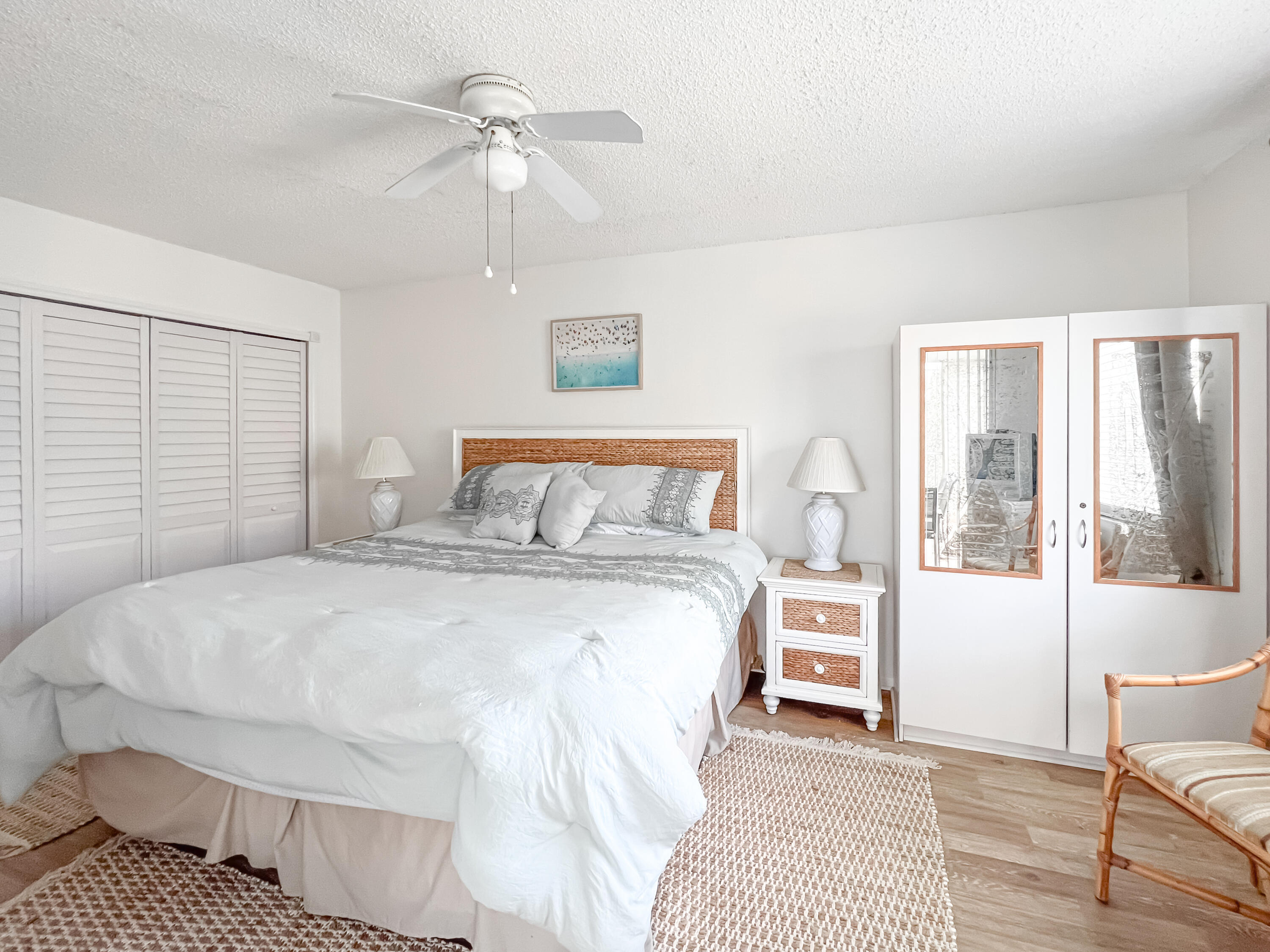 353 Highway 1, Unit B309 Jupiter, FL 33477 - Photo 8 of 24 a bedroom with a large bed and a chandelier