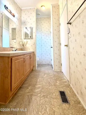 a white toilet sitting next to a shower